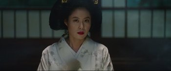 Movie still from “The Handmaiden” (2016), directed by Park Chan-wook – A woman wearing a white kimono and a black hat; Close Up shot, Over the shoulder angle