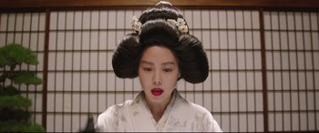 Movie still from “The Handmaiden” (2016), directed by Park Chan-wook – A young woman with long black hair wearing a white kimono; Close Up shot, Low angle