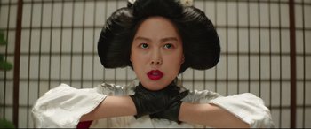 Movie still from “The Handmaiden” (2016), directed by Park Chan-wook – A woman with a black wig on her head; Close Up shot, Low angle