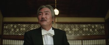 Movie still from “The Handmaiden” (2016), directed by Park Chan-wook – A man in a suit and a bow tie; Close Up shot, Low angle