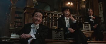 Movie still from “The Handmaiden” (2016), directed by Park Chan-wook – A couple of men sitting next to each other in a room; Medium shot, Low angle