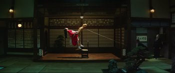 Movie still from “The Handmaiden” (2016), directed by Park Chan-wook – A man is doing a handstand trick on a stage; Extreme Wide shot, Low angle