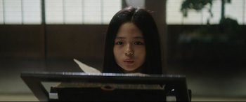 Movie still from “The Handmaiden” (2016), directed by Park Chan-wook – A young girl is sitting at a piano; Close Up shot, Low angle