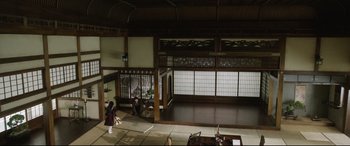 Movie still from “The Handmaiden” (2016), directed by Park Chan-wook – A woman walking in an oriental style room; Extreme Wide shot, High angle