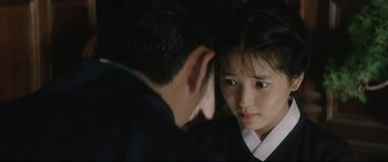 Movie still from “The Handmaiden” (2016), directed by Park Chan-wook – A young girl and a young man are looking at one another; Close Up shot, Over the shoulder angle