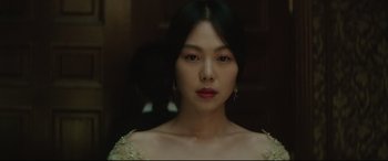 Movie still from “The Handmaiden” (2016), directed by Park Chan-wook – A woman in a white dress with red lipstick; Close Up shot, Over the shoulder angle