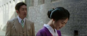 Movie still from “The Handmaiden” (2016), directed by Park Chan-wook – A man and a woman in a purple dress; Close Up shot, Over the shoulder angle