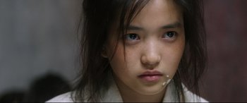 Movie still from “The Handmaiden” (2016), directed by Park Chan-wook – A young girl's face with blue eyes; Close Up shot, Over the shoulder angle