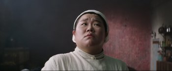 Movie still from “The Handmaiden” (2016), directed by Park Chan-wook – An asian man wearing a white hat looking upward; Close Up shot, Low angle