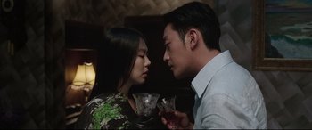 Movie still from “The Handmaiden” (2016), directed by Park Chan-wook – A man and a woman are holding wine glasses; Close Up shot, Over the shoulder angle