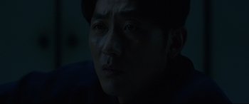Movie still from “The Handmaiden” (2016), directed by Park Chan-wook – A man's face in the dark; Close Up shot, Low angle