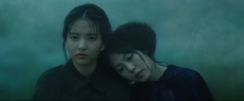 Movie still from “The Handmaiden” (2016), directed by Park Chan-wook – Two young women sitting next to each other in a room; Close Up shot, Low angle
