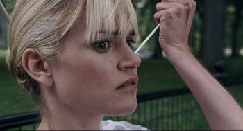 Movie still from “The Happening” (2008), directed by M. Night Shyamalan – A person holding a straw in her mouth; Close Up shot, Low angle