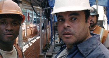 Movie still from “The Happening” (2008), directed by M. Night Shyamalan – A man in a hard hat is looking at the camera; Close Up shot, Low angle