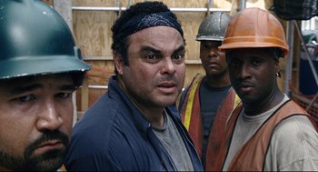 Movie still from “The Happening” (2008), directed by M. Night Shyamalan – A group of construction workers standing next to each other; Close Up shot, Over the shoulder angle