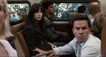 Movie still from “The Happening” (2008), directed by M. Night Shyamalan – A man and a woman sitting next to each other on a train; Medium shot, Over the shoulder angle