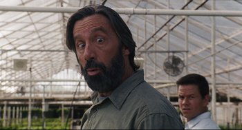 Movie still from “The Happening” (2008), directed by M. Night Shyamalan – A man with long hair and a goatee looking surprised; Close Up shot, Low angle