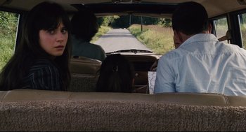 Movie still from “The Happening” (2008), directed by M. Night Shyamalan – A woman sitting in the back seat of a car with two men; Close Up shot, Over the shoulder angle