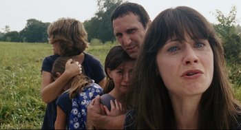 Movie still from “The Happening” (2008), directed by M. Night Shyamalan – A group of people standing next to each other in a field; Close Up shot, Low angle