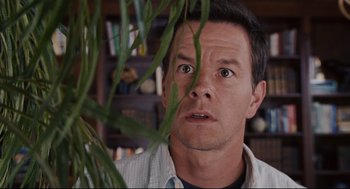 Movie still from “The Happening” (2008), directed by M. Night Shyamalan – A person with a plant; Close Up shot, Low angle