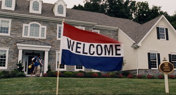 Movie still from “The Happening” (2008), directed by M. Night Shyamalan – A welcome flag in front of a house; Extreme Wide shot, Low angle