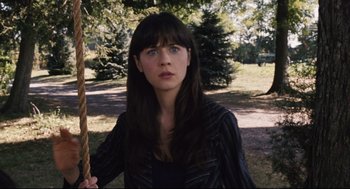 Movie still from “The Happening” (2008), directed by M. Night Shyamalan – A woman with long black hair is holding a rope; Close Up shot, High angle