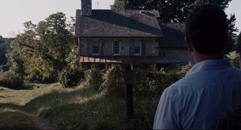 Movie still from “The Happening” (2008), directed by M. Night Shyamalan – An old house in the middle of a grassy field; Wide shot, Low angle