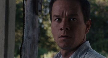 Movie still from “The Happening” (2008), directed by M. Night Shyamalan – A man's face with trees in the background; Close Up shot, Low angle