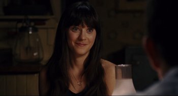 Movie still from “The Happening” (2008), directed by M. Night Shyamalan – A woman with long black hair smiles for the camera; Close Up shot, Over the shoulder angle