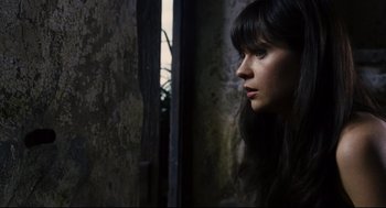 Movie still from “The Happening” (2008), directed by M. Night Shyamalan – A woman with long black hair looking out a window; Close Up shot, High angle