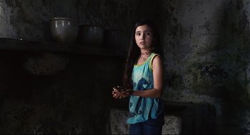 Movie still from “The Happening” (2008), directed by M. Night Shyamalan – A young girl is holding something in her hands; Medium shot, Low angle