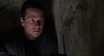 Movie still from “The Happening” (2008), directed by M. Night Shyamalan – A person with his head on a wall; Close Up shot, Overhead angle