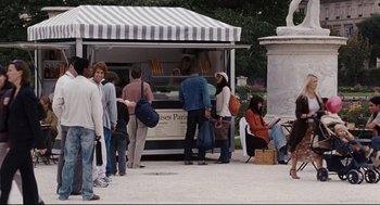 Movie still from “The Happening” (2008), directed by M. Night Shyamalan – A group of people standing around a food stand; Wide shot, Over the shoulder angle