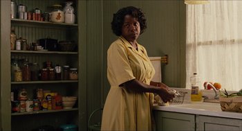 Movie still from “The Help” (2011), directed by Tate Taylor – An older woman standing in front of a kitchen sink; Medium shot, Low angle