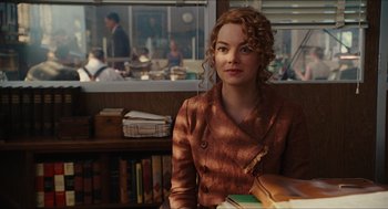Movie still from “The Help” (2011), directed by Tate Taylor – A woman sitting at a table in front of a window; Medium shot, Over the shoulder angle