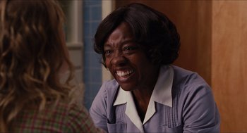 Movie still from “The Help” (2011), directed by Tate Taylor – An older black woman smiling at the camera; Close Up shot, Over the shoulder angle