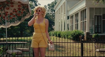 Movie still from “The Help” (2011), directed by Tate Taylor – A woman in a yellow outfit talking on a phone; Wide shot, Low angle