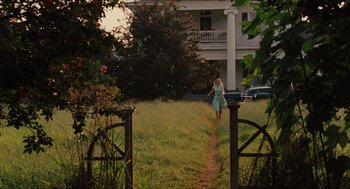 Movie still from “The Help” (2011), directed by Tate Taylor – A woman walking down a path in front of a white house; Extreme Wide shot, High angle