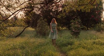 Movie still from “The Help” (2011), directed by Tate Taylor – A woman in a green dress walking through a field; Wide shot, Low angle