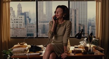 Movie still from “The Help” (2011), directed by Tate Taylor – A woman talking on a phone while sitting on a desk; Medium shot, Over the shoulder angle
