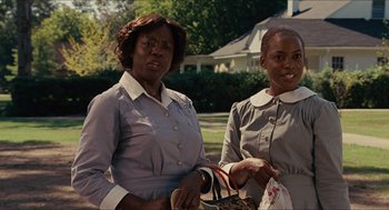 Movie still from “The Help” (2011), directed by Tate Taylor – Two women standing next to each other in front of a house; Medium shot, Low angle