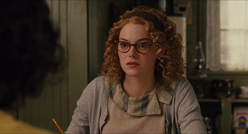 Movie still from “The Help” (2011), directed by Tate Taylor – A woman with curly red hair wearing glasses; Close Up shot, Over the shoulder angle