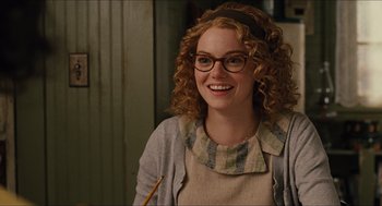 Movie still from “The Help” (2011), directed by Tate Taylor – A woman with curly red hair wearing glasses and holding a pencil; Close Up shot, Over the shoulder angle