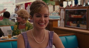 Movie still from “The Help” (2011), directed by Tate Taylor – A woman sitting at a table wearing a purple dress; Close Up shot, Over the shoulder angle