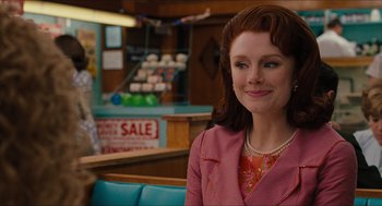 Movie still from “The Help” (2011), directed by Tate Taylor – A woman sitting in a booth at a restaurant; Medium shot, Over the shoulder angle