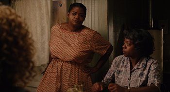 Movie still from “The Help” (2011), directed by Tate Taylor – Two women standing next to each other in front of a window; Medium shot, Over the shoulder angle