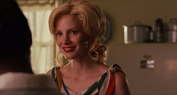 Movie still from “The Help” (2011), directed by Tate Taylor – A woman with blonde curly hair smiling for the camera; Close Up shot, Over the shoulder angle