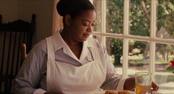 Movie still from “The Help” (2011), directed by Tate Taylor – A woman sitting in front of a plate of food; Close Up shot, Over the shoulder angle
