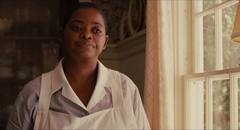 Movie still from “The Help” (2011), directed by Tate Taylor – A woman standing in front of a window wearing an apron; Close Up shot, Over the shoulder angle