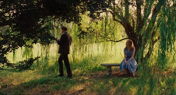 Movie still from “The Help” (2011), directed by Tate Taylor – A man and a woman sitting on a bench under a tree; Wide shot, High angle